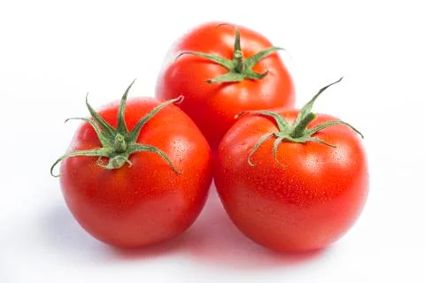 Three red tomatoes on a white background Stock Photos