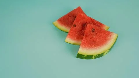 Three red watermelon slices on turquoise background. Stock Photos