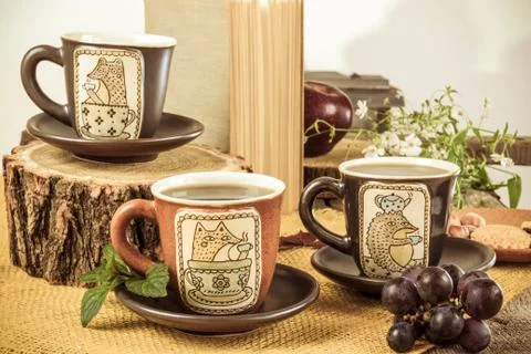 Three retro empty cups for tea on retro wooden table Stock Photos