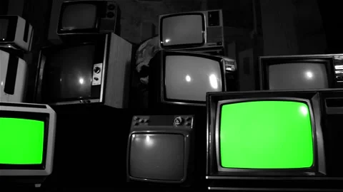 Three Retro TVs Green Screen over a Pile of 80s TVs. Black and White Tone. Stock Footage 98659503