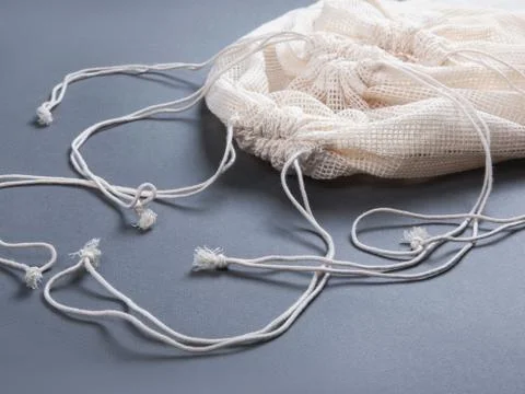 Three reusable string bags for different products, closeup. Stock Photos