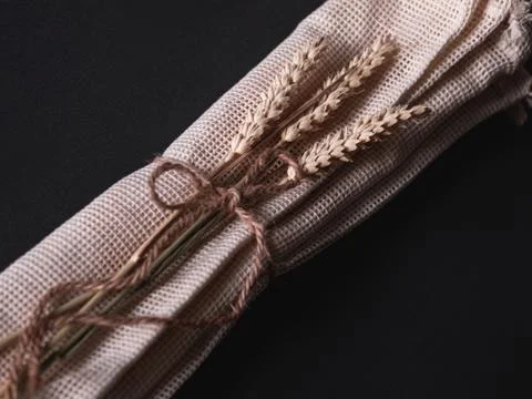 Three reusable string bags with three branches of wheat, closeup. Stock Photos