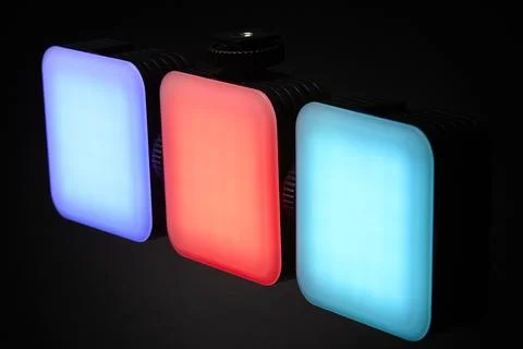 Three RGB LED light panels with red and blue glow on black Stock Photos