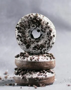 Three ring donuts with icing and chocolate pieces Stock Photos