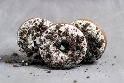 Three ring donuts with icing and chocolate pieces Stock Photos