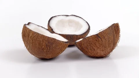 Three ripe coconut halves with yummy pulp rotating on white isolated background Stock Footage 87618441
