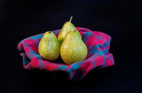 Three ripe pears rest elegantly in a bowl Stock-Fotos