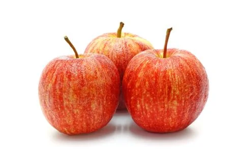 Three ripe red apples isolated on a white background. Stock Photos