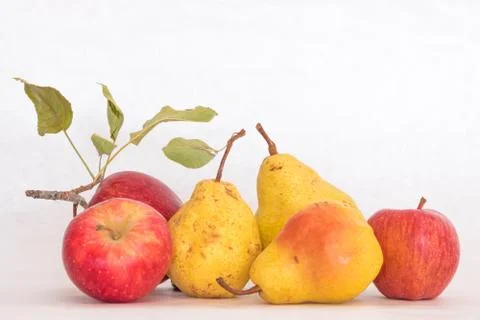Three ripe yellow skinned pears and red apples, fresh organic beautiful studio Stock Photos