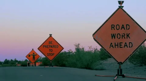 Three Road Hazard Signs Warn Motorists of Construction Ahead Stock Footage 64365056