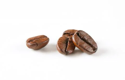 Three roasted coffee beans close up Stock Photos
