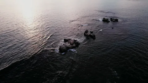 Three rock formations by the serene ocean during daytime Stock Footage 310316328