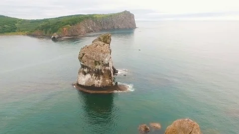 Three rocks in the ocean. Rock in the sea. Birds on the coast of the island in Stock Footage 73523573
