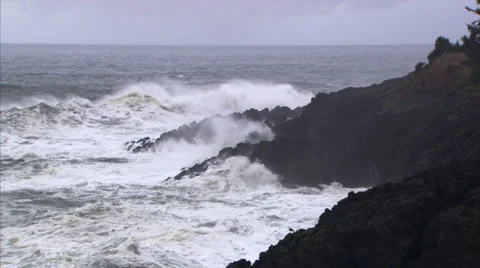 Three rocky out-thrusts with high waves exploding at their bases Stock Footage 59535135