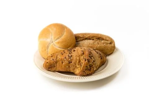 Three rolls of bread on an off-white plate isolated on a white background Foto stock