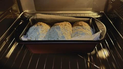 Three rolls of  Final proof dough lined with  parchment paper is in Oven Foto stock