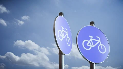 Three rotating bicycle lane signs on poles against sky, modern 3D traffic sign Stock Footage 336317051