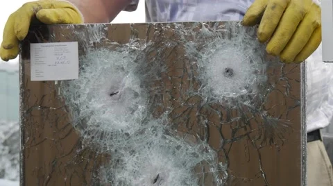 Three Round Cracks and a Lot of Fractures From Bullets Used to Test the Stock Footage 53007910