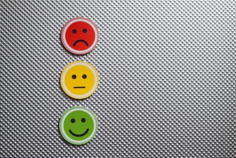 Three round emoji faces in red, yellow, and green representing sad, neutral, and Stock Photos