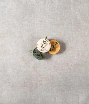 Three round natural handmade soaps on the cotton background with the space. Stock Photos