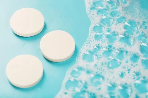 Three round pieces of white soap with foam Foto stock