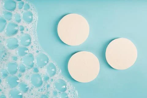 Three round pieces of white soap with foam Foto stock