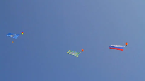 Three in a row hovering in the sky flag on a holiday parachutists Stock Footage 28364918