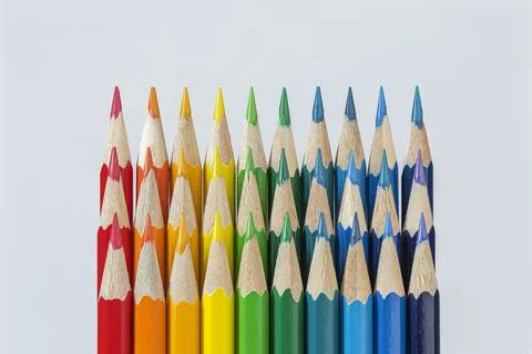 Three rows of colored pencils against a white background. Stock Photos