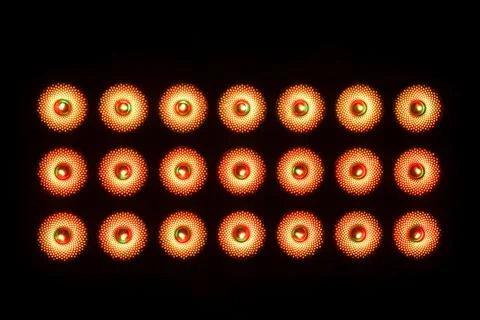 Three rows of LED illuminators on a black background. Frontal view. Stock Photos