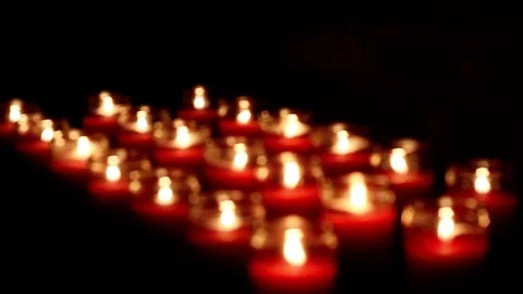 Three rows of red glowing candles in a dark church setting. Stock Footage 72602112