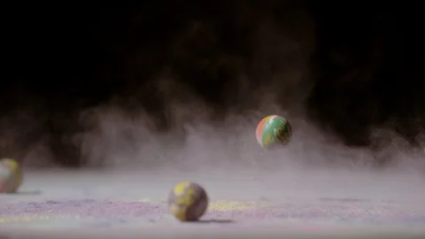 Three rubber balls dropped in colored powder, Ultra Slow Motion Stock Footage 86576747