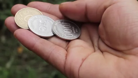 Three rupiah coins that a man shows with h Stock Footage 218423801