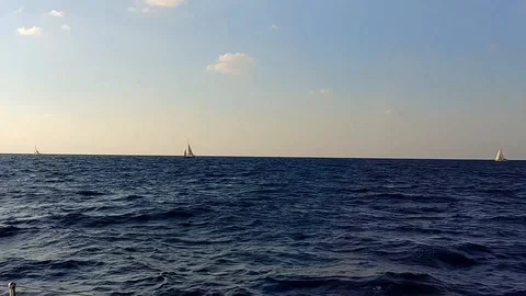 Three sail yacht in horizon, view from the sea Stock Footage 97065341