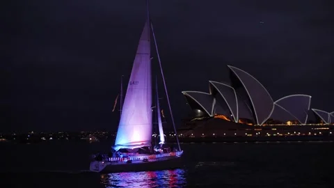 Three sailing boats at night pass Sydney Opera House slow motion 4K Video stock 264233961