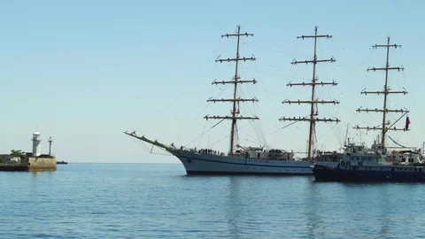 A three-sailing ship is sailing to the port in Yalta 4k Stock Footage 113878904
