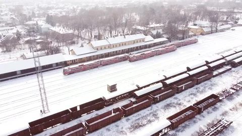 Three same red diesel trains at the railway station covered by snow. Stock Footage 149825215