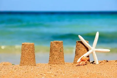 Three sand towers on beach Stock Photos