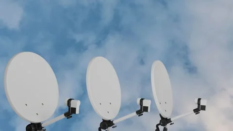 Three satellite dishes on the background of blue sky Stock Footage 313737611