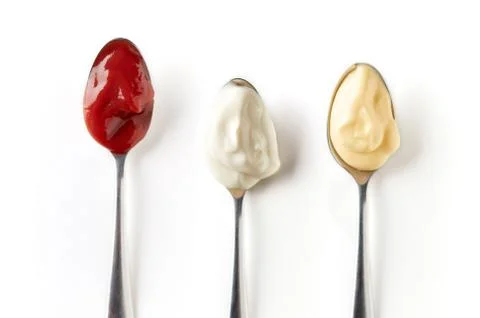 Three sauces in spoons isolated on white, from above Stock Photos