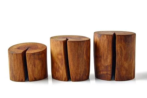 Three sawn brown tree trunks with knots and cracks isolated on a white Stock Photos