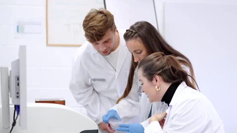 Three scientist coworkers analysing samples Stock Footage 255196363