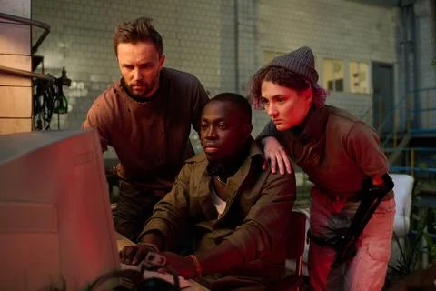 Three Scientists Using Old Computer In Abandoned Building Stock Photos