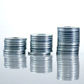 Three screw washer columns with reflection, white grey background. Stock Photos