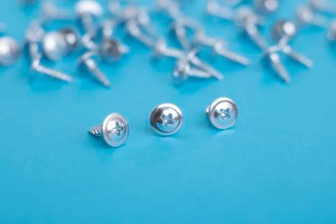 Three screws and blurred background, nobody. Horizontal Stock Photos