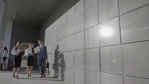 Three Self-Confident People Students go and Talk With Documentation on Stock Footage 72653107