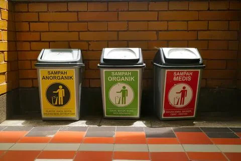 Three separate trash bins for organic, inorganic, and medical waste Stock Photos