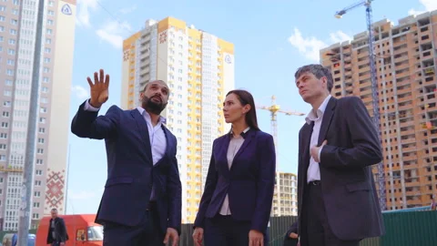Three serious businessmen two men and a woman discussing a project under Stock Footage 89031815