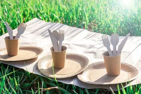 Three sets of disposable biodegradable tableware  on nature. Stock Photos