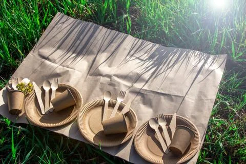 Three sets of disposable biodegradable tableware for an outdoor picnic. Stock Photos