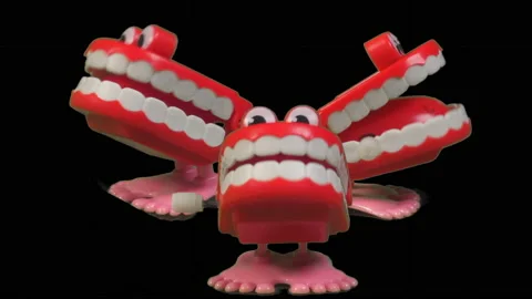 Three sets of fun toy joke chatty teeth chattering together. Stock Footage 239342198